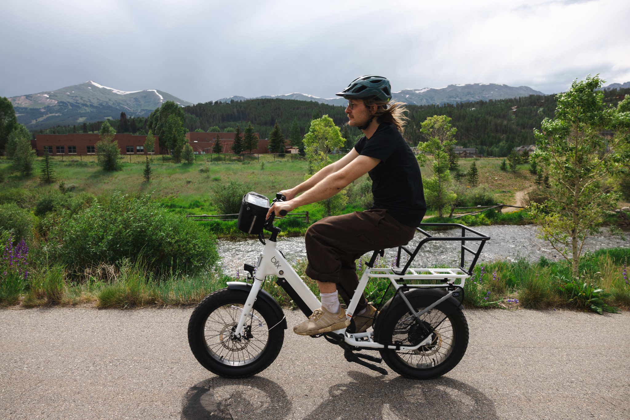 Close-up shot of a man cruising on an ebike on the Rec Path in Breckenridge, Colorado.